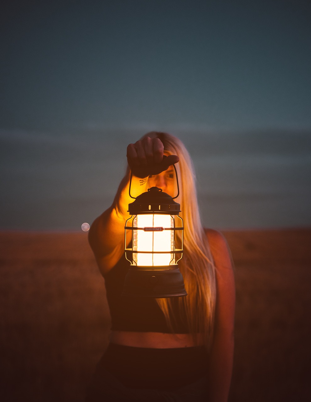 Girl holding lantern in the dark