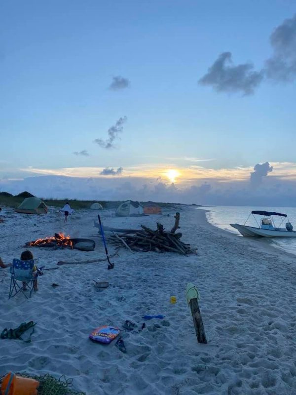 camping on beach scene with fire and tent